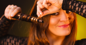 women curling her hair rotating hair around wand