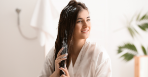 women applying leave-in conditioner in her hair