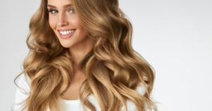 How to Rock the Wolf Cut for Curly Hair 2023 Comprehensive Guide 2 A woman with long blond wavy hair smiling